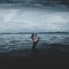 hand rising out of the dark ocean