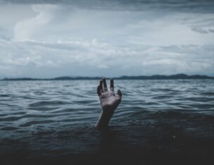 hand rising out of the dark ocean